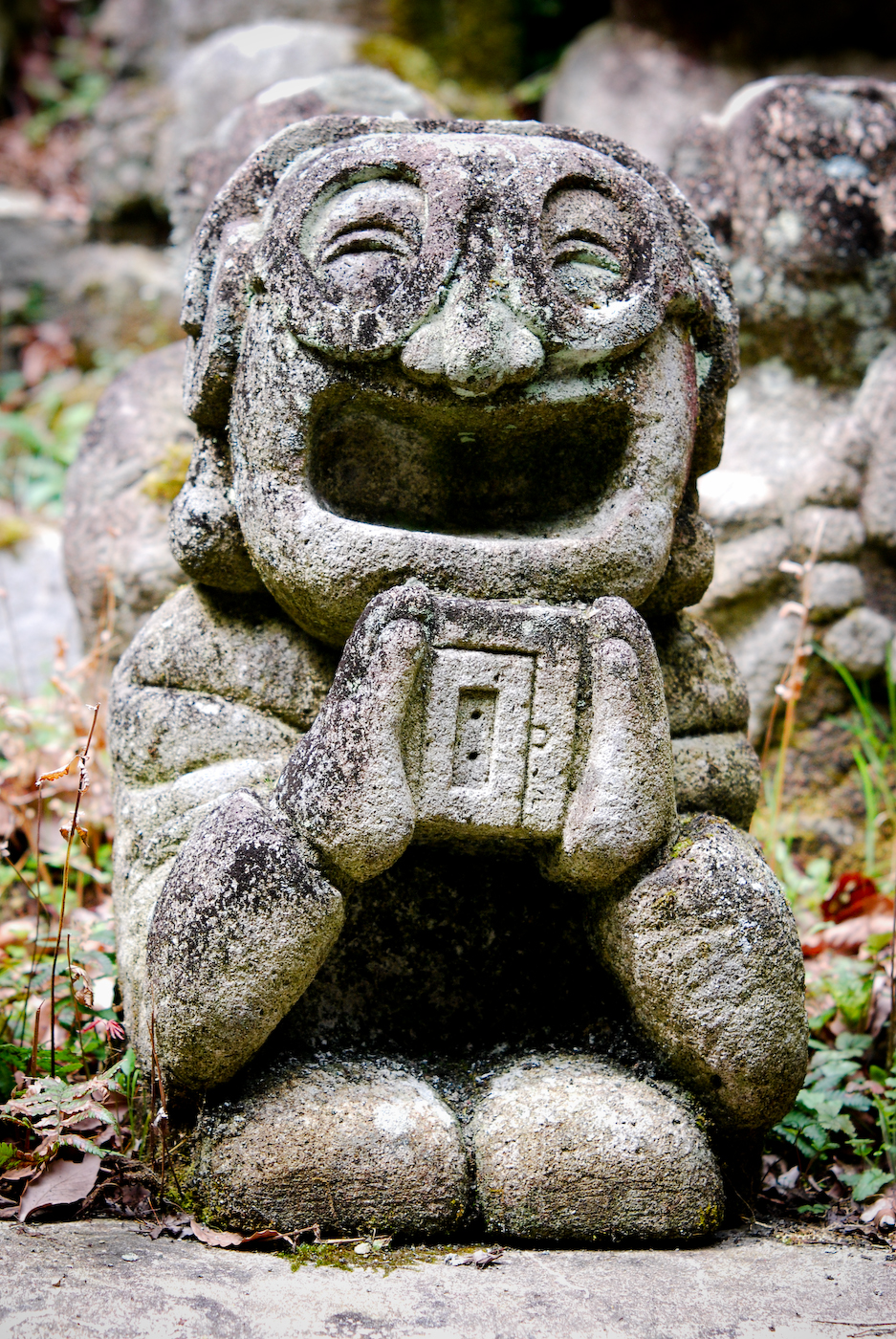 Stone statue holding an object in Arashiyama